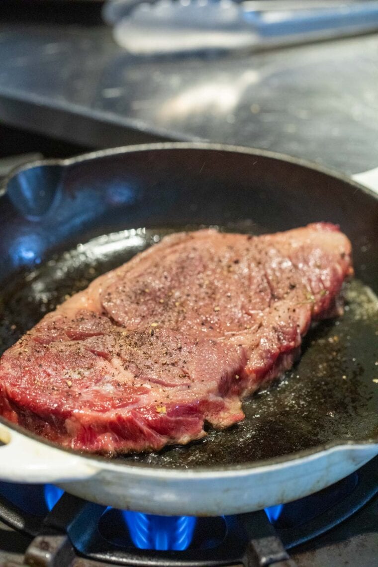 Starting the steak sear in a skillet.