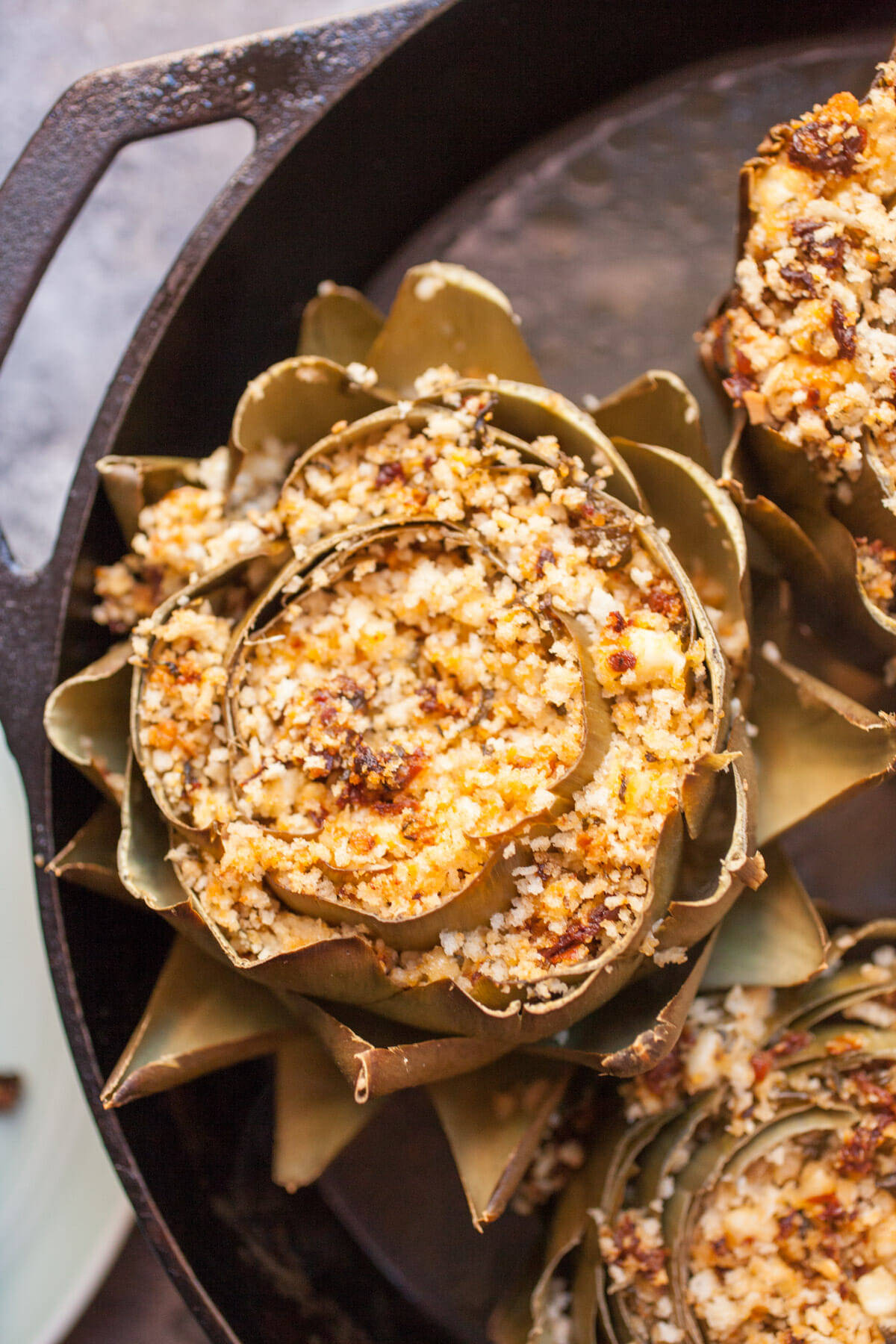 Stuffed Artichokes: These roasted artichokes are stuffed with a mix of delicious flavors like sun-dried tomatoes, feta, and basil. What a great appetizer! | macheesmo.com