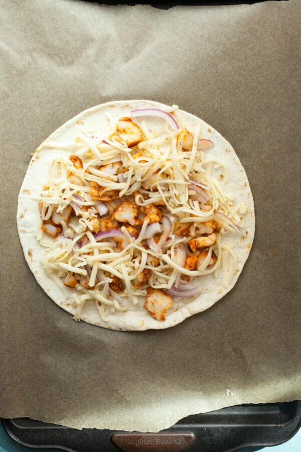 Making shrimp quesadillas in the oven.