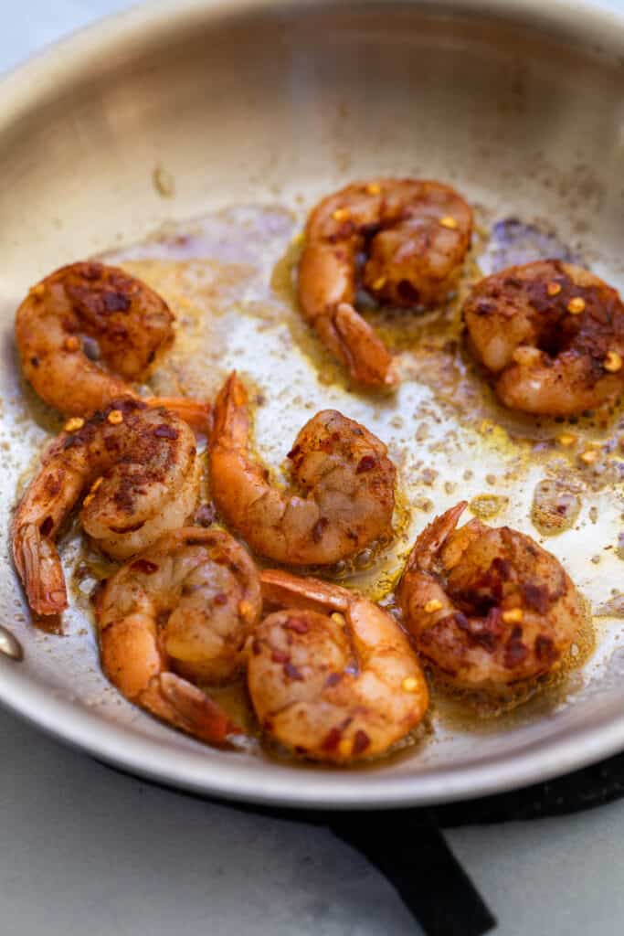 Shrimp cooked in a skillet for Cajun shrimp and grits.