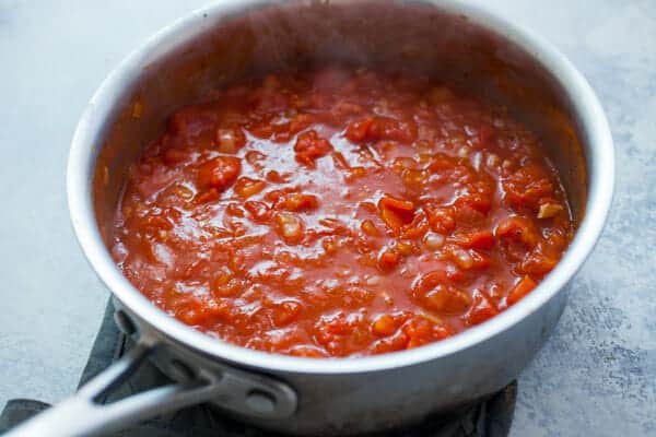 Making the tomato sauce for the baked egg dish.