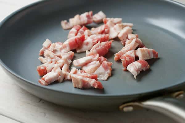 Bacon cooking in skillet.