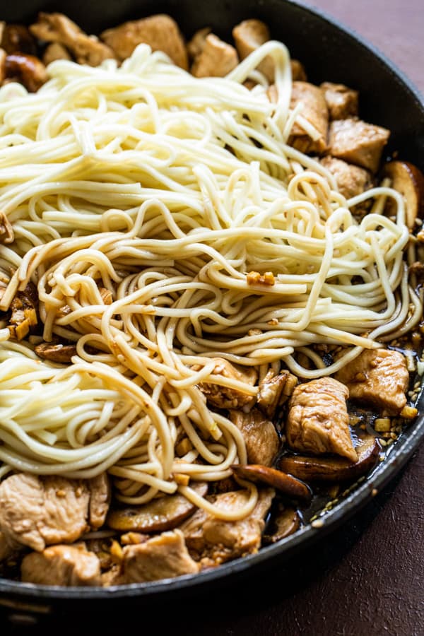 Sauce and noodles added to lo mein.