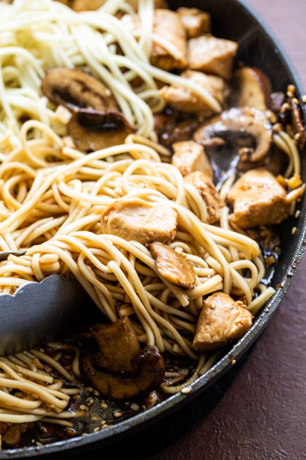 Tossing everything together for chicken and mushroom lo mein