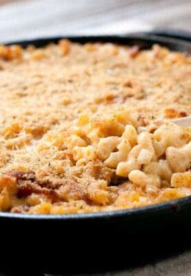 Cast Iron Macaroni and Cheese: A made-from-scratch mac and cheese with just enough bacon and spice, mixed together and baked in a cast iron skillet for crispy edges!
