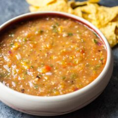 Easy grilled salsa with fresh tomatoes, tomatillos, onions, and sweet peppers. All charred on a grill and blended together. The best salsa you'll have this summer and easy to make!