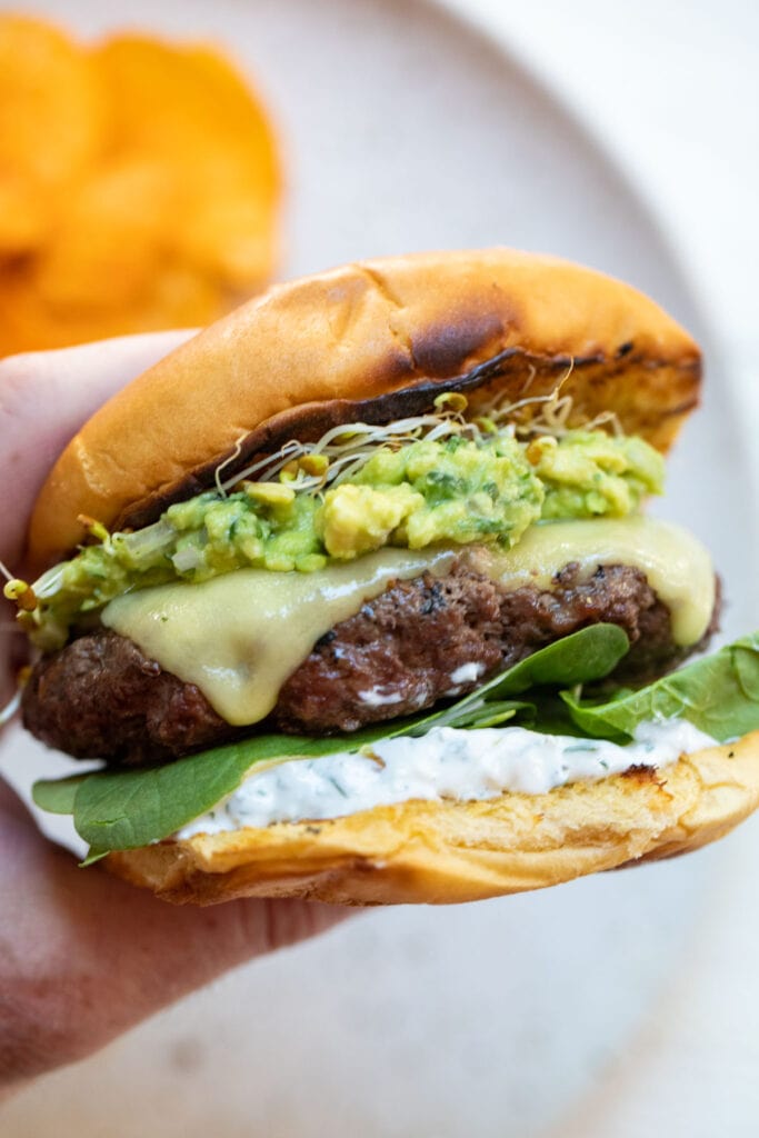 My take on the Green Goddess Burger featuring a parsley yogurt sauce, avocado relish, and loads of green vegetables!