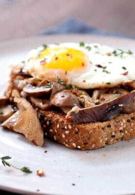 Creamed Mushrooms on Toast: One of my favorite simple breakfasts. Good hearty mushrooms, simply sauteed in olive oil with a few spices and simmered in a little cream. Piled onto sturdy toast with a few eggs! | macheesmo.com