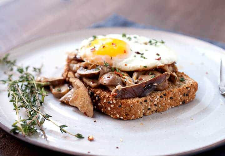 Creamed Mushrooms on Toast: One of my favorite simple breakfasts. Good hearty mushrooms, simply sauteed in olive oil with a few spices and simmered in a little cream. Piled onto sturdy toast with a few eggs! | macheesmo.com