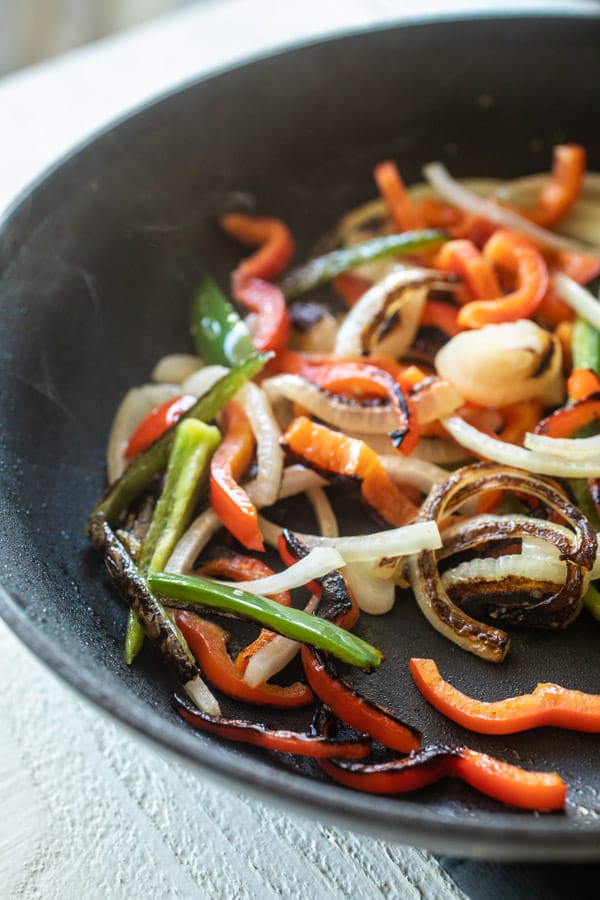 Peppers and onions caramelized in skillet.