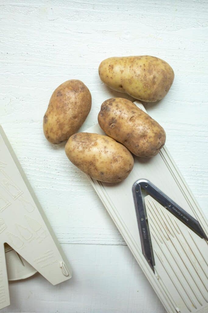 Slicing potatoes with Mandolin slicer