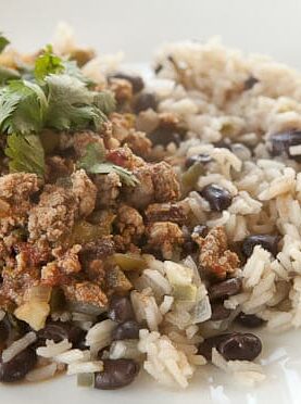 Classic Cuban Picadillo with ground beef and spices served over rice and black beans. A hearty plate of food to warm the soul!