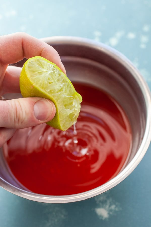 Making the michelada mix with clamato juice.