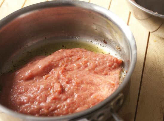 Adding tomato - Puttanesca Sauce
