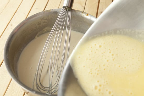 Whisking custard together for sauce
