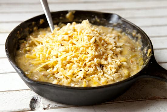 Adding cheese to chorizo queso dip