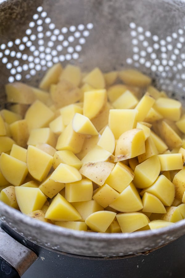 Par boiling the potatoes after cubing them.