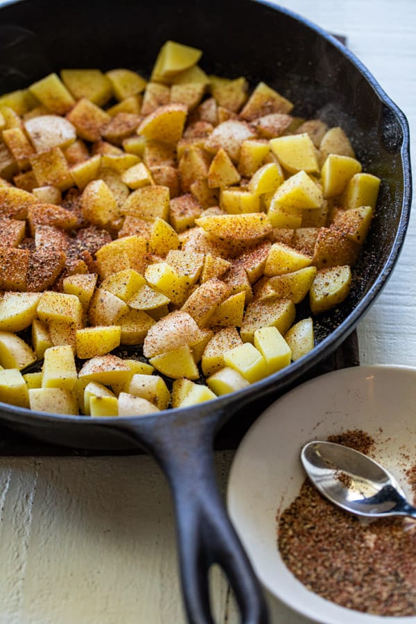 Starting to cook home fries in the cast iron skillet.