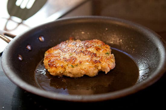 Cooking a shrimp burger in a skillet.