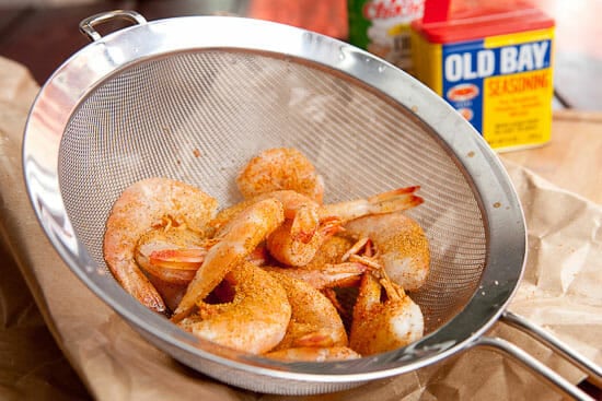 Seasoning the shrimp.