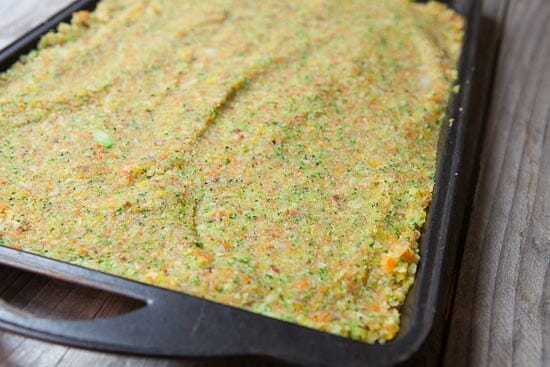 Vegetable mixture spread out on a baking sheet.