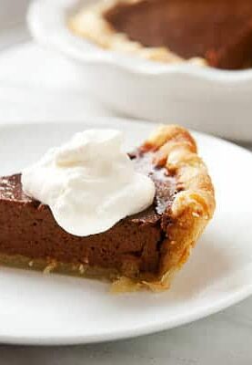 My version of Chef Symon's chocolate pumpkin pie made in a homemade all-butter crust. A really nice change on the classic pumpkin pie! macheesmo.com #pumpkinpie #chocolate #holiday #baking