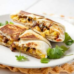 The breakfast crunch wrap filled with eggs, vegetables and cheese. The perfect breakfast burrito for the indecisive Tex-Mex lover!