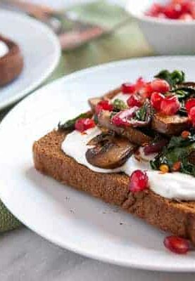Savory Mushrooms on Toast: Sauteed mushrooms and Swiss chard served over crispy pumpernickel toast with some bonus goodies packed on!