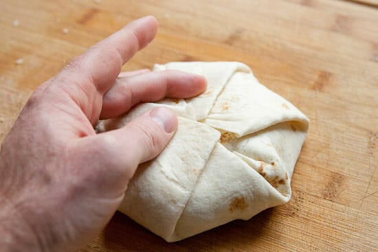 Folding a crunch wrap.