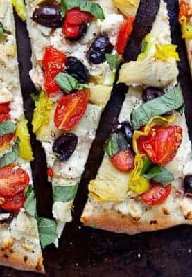 Mediterranean Flatbreads: Deflated easy to make flatbreads with no yeast. The result is almost a cracker-like crispy crust topped with any toppings you like! I chose a bunch of fun Mediterranean toppings for my version.