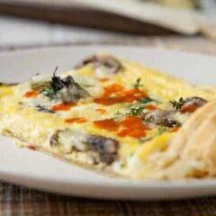 Puff Pastry Frittata: An easy breakfast dish packed with mushrooms and spinach and baked in a sheet pan. The finished dish is nice and thin and has a great crust!