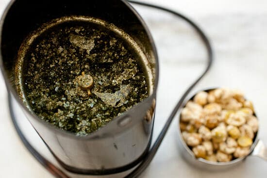 Grinding seaweed seasoning.