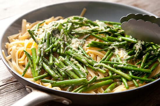 Finishing the asparagus carbonara in a skillet. 