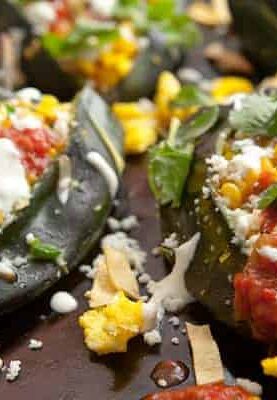 Tex-Mex Breakfast Stuffed Peppers: Roasted Poblano peppers stuffed with eggs, corn strips, corn, queso fresco, salsa, and a light sour cream sauce! This is one good breakfast pepper! | macheesmo.com