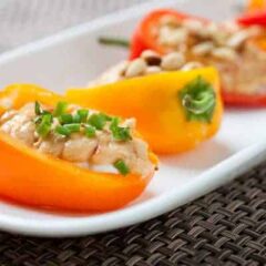 Stuffed Sweet Peppers: Whipped goat cheese and spicy hummus layered in crunchy, crisp sweet peppers and topped with various garnishes. The perfect, quick summer appetizer!