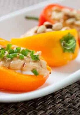 Stuffed Sweet Peppers: Whipped goat cheese and spicy hummus layered in crunchy, crisp sweet peppers and topped with various garnishes. The perfect, quick summer appetizer!