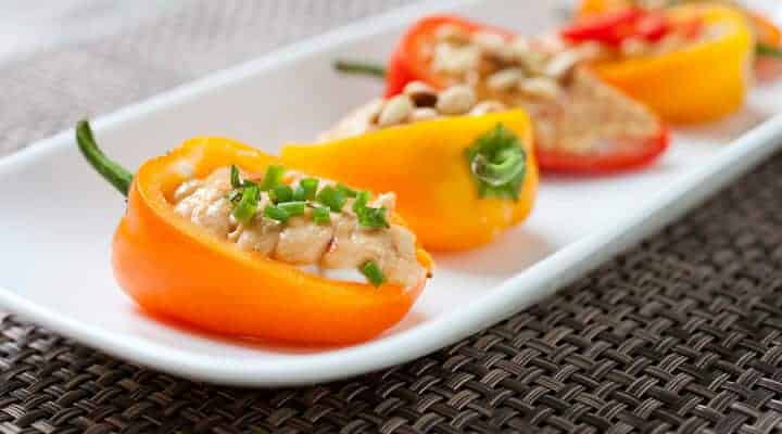 Stuffed Sweet Peppers: Whipped goat cheese and spicy hummus layered in crunchy, crisp sweet peppers and topped with various garnishes. The perfect, quick summer appetizer!