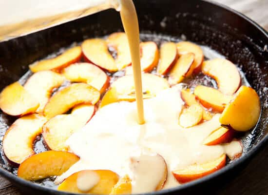 Adding batter to cast iron skillet.