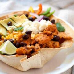Chipotle Chicken Taco Bowls! I don't mean Chipotle like the restaurant, these chicken taco bowls are so much better! Spicy chipotle chicken layered with corn, black beans, cilantro rice, and other great taco toppings in an edible taco bowl! | macheesmo.com