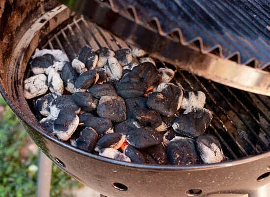 Preparing grill for chicken wings.