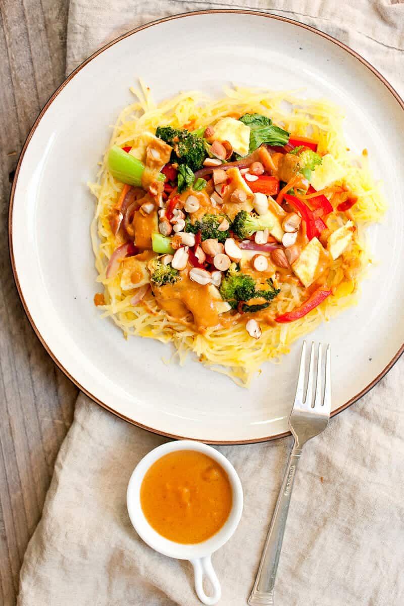 Thai Spaghetti Squash with Peanut Sauce: This roasted spaghetti squash is amped up with a veggie stir-fry topper, eggs, and a spicy homemade peanut sauce. EASY to make and perfect for fall! | macheesmo.com