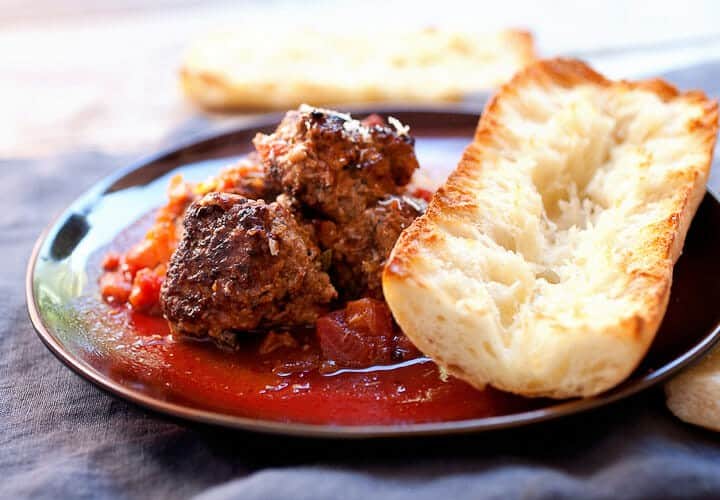 Easy Braised Meatballs: These delicious homemade braised meatballs are slow-simmered in tomatoes and red wine and so good served over pasta or with a crusty piece of bread. You could even make a sandwich out of them! | macheesmo.com