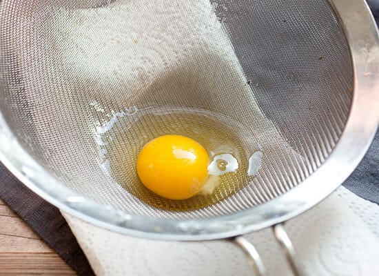 Straining eggs.