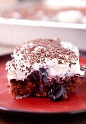 Black Forest Sheet Cake: Rich (but easy to make) chocolate sheet cake topped with loads of sweet cherries, whipped cream, and shaved chocolate. The nice thing about sheet cake is you can cut as big of a piece as you want! | macheesmo.com