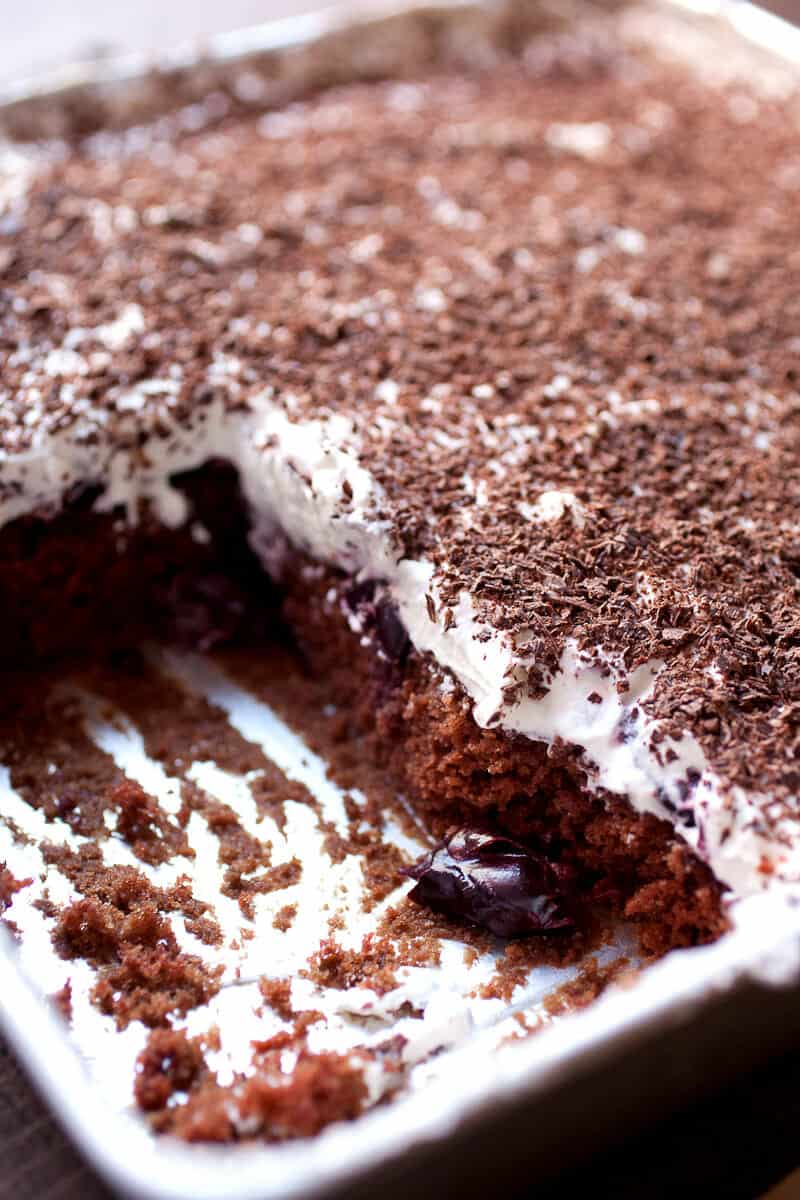 Black Forest Sheet Cake: Rich (but easy to make) chocolate sheet cake topped with loads of sweet cherries, whipped cream, and shaved chocolate. The nice thing about sheet cake is you can cut as big of a piece as you want! | macheesmo.com