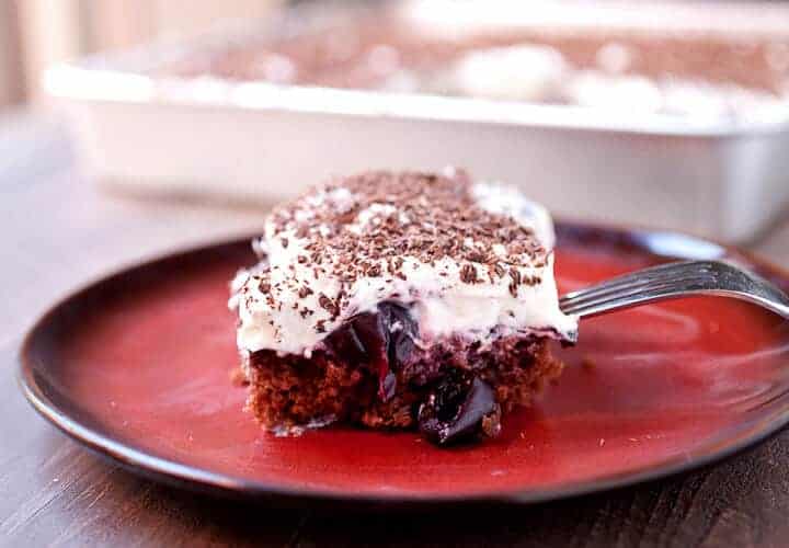 Black Forest Sheet Cake: Rich (but easy to make) chocolate sheet cake topped with loads of sweet cherries, whipped cream, and shaved chocolate. The nice thing about sheet cake is you can cut as big of a piece as you want! | macheesmo.com