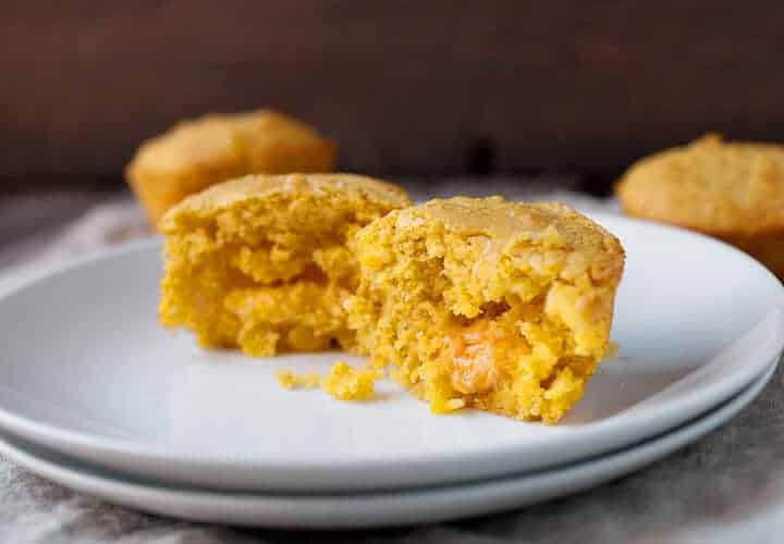 Cheddar Stuffed Corn Muffins: These delicious and savory corn muffins are stuffed with a huge chunk of cheddar cheese. It's like a little bonus when you break into the muffin. Good as a side dish for so many meals. It's the corn muffin you've been waiting for! | macheesmo.com