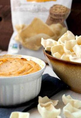 Spicy Cauliflower Dip: This healthy dip is a great substitution for a classic baked cheese dip. It has just enough sharp cheddar and is loaded with pureed cauliflower and delicious spices. I like to serve mine with Simply7 Lentil chips! #sponsored | macheesmo.com