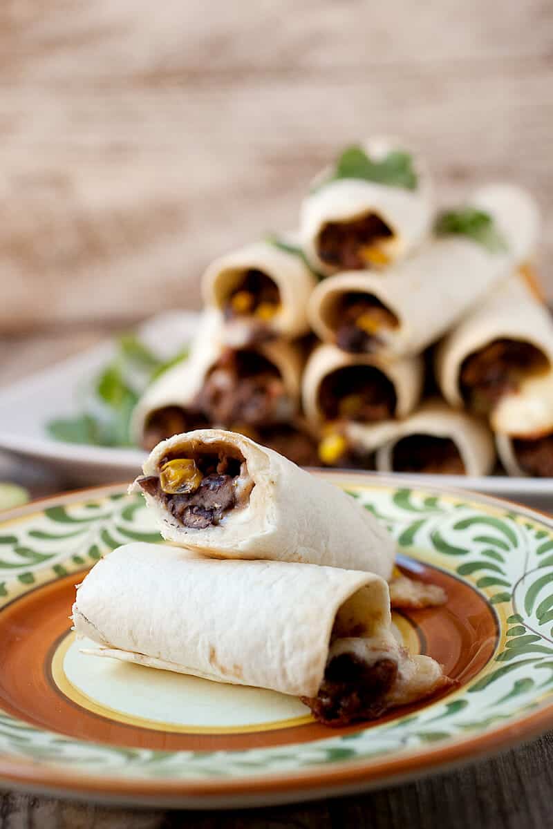 Simple Bean and Cheese Flautas: These Tex-Mex "flutes" are filled with pepper jack cheese and a quick black bean and corn mash. A plate of them makes for great appetizers or stack up a few and make a quick meal out of them! | macheesmo.com