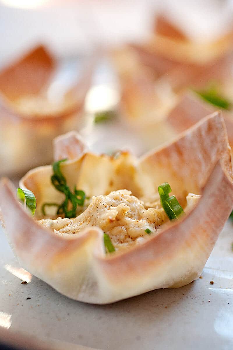 Hot Crab Dip Wonton Cups: These are the most addictive little bites you'll find on an appetizer table. Hot crab dip spiced with Old Bay seasoning, shallot, and just a dash of hot sauce. Baked right into a crispy wonton cup! | macheesmo.com